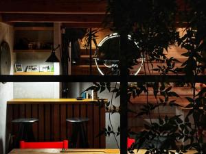 a room with two stools and a counter with a bar at Hameau de la Côte in Les Houches