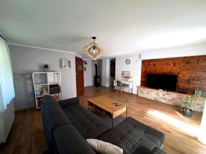 a living room with a couch and a table at Nasz Zakątek in Mysłakowice