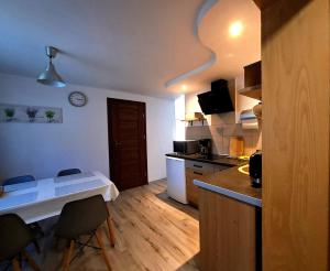 a kitchen with a table and chairs in a room at Nasz Zakątek in Mysłakowice