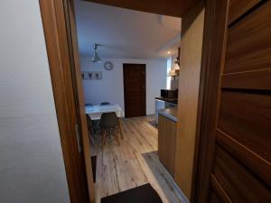 a room with a kitchen with a table and a door at Nasz Zakątek in Mysłakowice +18 photos