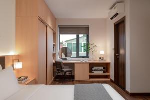 En eller flere senge i et værelse på Keypad Hotel - Linh Lang