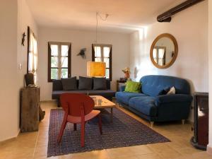 a living room with a blue couch and a table at sea sunset view, walk to the beach in Gümüşlük