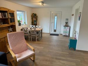 a living room with a table and a chair at Am Sonnenhang in Hilzingen
