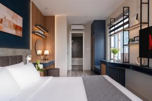 En eller flere senge i et værelse på Keypad Hotel - Linh Lang