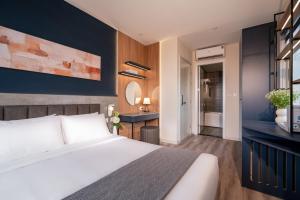 En eller flere senge i et værelse på Keypad Hotel - Linh Lang