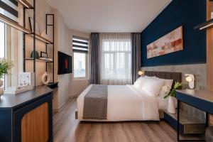 En eller flere senge i et værelse på Keypad Hotel - Linh Lang