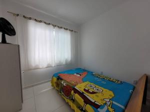 a bedroom with a bed with a cartoon character on it at Casa de praia com wi-fi in Barra Velha +6 photos