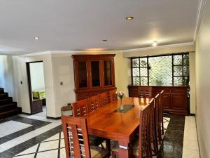 a dining room with a wooden table and chairs at Great House, Amazing location!! in Cochabamba