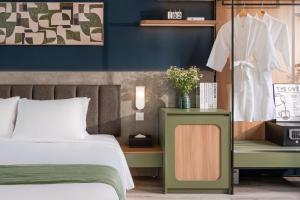 En eller flere senge i et værelse på Keypad Hotel - Linh Lang