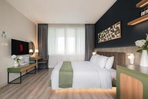 En eller flere senge i et værelse på Keypad Hotel - Linh Lang