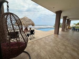 a swing hanging from a house with a swimming pool at Tortugas Nest Resort in Miramar +15 photos