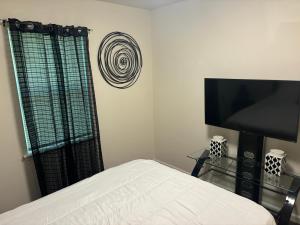 a bedroom with a bed and a flat screen tv at Atlanta Cozy Private Room 4 in Atlanta