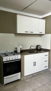 a kitchen with a stove and a sink in it at Alquiler Temporario Perico 1 in Perico