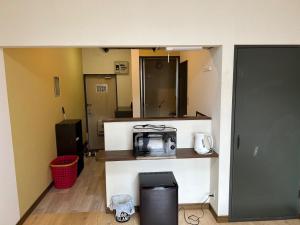 a kitchen with a counter with a microwave on it at Chambord Kyomachi 102,103,108,201,202,205,206,207 - Vacation STAY 19070v in Kumamoto