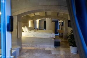 a bedroom with a large bed in a stone room at Be Still Alexa Smart Luxury Escape Adults Only in Nevşehir +135 photos