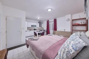 a bedroom with a large bed and a kitchen at Relax apartment in Bratislava