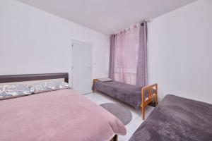 a bedroom with two beds and a window at Relax apartment in Bratislava