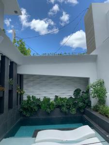 a swimming pool in the backyard of a house at Trópica Beach Hotel in San Juan