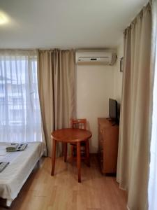 a small room with a table and a bed and a window at Aria private apartments in Fort Noks Grand Resort - Saint Vlas in Elenite +6 photos