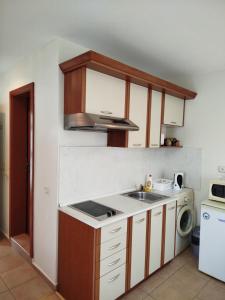 a kitchen with a sink and a stove at Aria private apartments in Fort Noks Grand Resort - Saint Vlas in Elenite