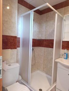 a bathroom with a shower with a toilet and a sink at Aria private apartments in Fort Noks Grand Resort - Saint Vlas in Elenite
