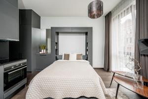 Ένα ή περισσότερα κρεβάτια σε δωμάτιο στο Vilnius Old-Town Renaissance Studios