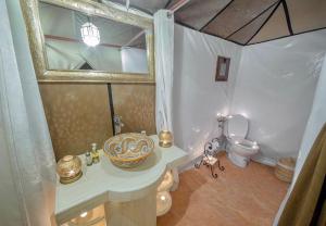 a bathroom with a sink and a toilet at Anir Luxury Camp - Gites et Tentes de Luxe in Merzouga