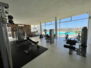 a gym with exercise equipment and a view of the ocean at Blue Mazatlán in Mazatlán