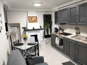 a kitchen with a table and a fireplace at La Casa dei Ricordi in Toro
