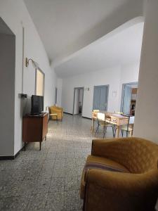 a living room with a couch and a table at Casa Vacanze Zarinu Orgosolo in Orgosolo
