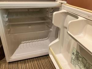 an empty refrigerator with its door open in a kitchen at Miyakonojo City Hotel - Vacation STAY 15151v in Miyakonozyō