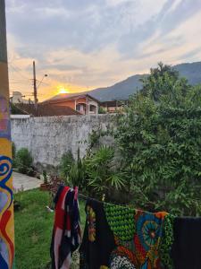 a group of clothes hanging on a clothes line at Quarto para mulheres in Ubatuba