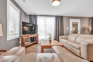 a living room with a couch and a tv at Cozy 4 Bedroom Home in Cornwall in Cornwall