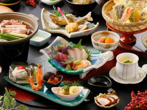 a table with many different dishes of food on it at Miyakonojo City Hotel - Vacation STAY 15150v in Miyakonozyō