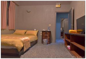 Postel nebo postele na pokoji v ubytování Jheng Tong House