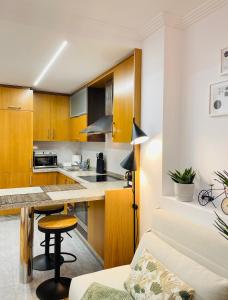 a kitchen with wooden cabinets and a table in a room at Las Terrazas de Vigo - David in Vigo +17 photos
