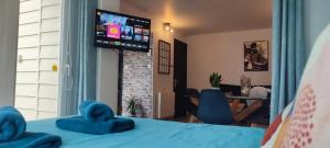 a bedroom with a bed with blue towels on it at Le petit chez soi in Le Portel