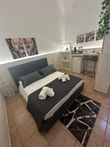 a bedroom with a bed with towels on it at House Lurokè in Catania