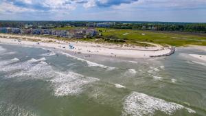 an aerial view of a beach with a group of people at Luxury 7BR w Ocean Views & Private Pool in Hilton Head Island +80 photos