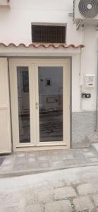 a door to a building with a window at Casa della Nonna in Montalbano Jonico