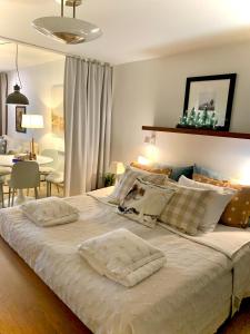 a bedroom with a large bed with two pillows on it at Holiday Home Birdie in Naantali