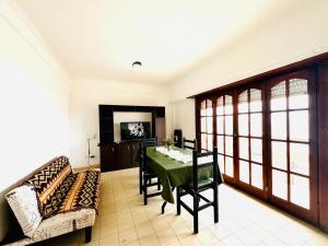 a dining room with a table and a couch at Departamento A Mar in Mar del Plata