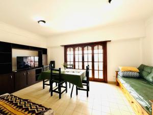 a living room with a table and a couch at Departamento A Mar in Mar del Plata +7 photos