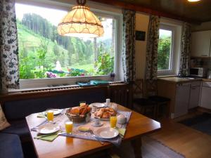 a table with food on it in a room with a window at Enghagen Haarstube in Vorderstoder