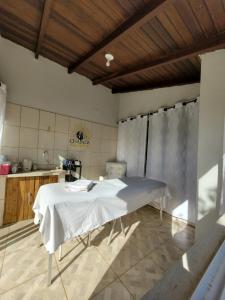 a kitchen with a table in the middle of a room at Pousada Chapada Equilibrio in Chapada dos Guimarães