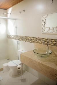 a bathroom with a sink and a toilet at Pousada Casa Mendes in Guapimirim +13 photos