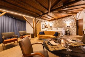 a hotel room with a bed and a table and chairs at Aruanã Eco Praia Hotel in Aracaju
