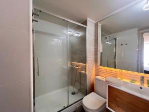 a bathroom with a shower and a toilet and a sink at Living Rosas in Santiago +28 photos