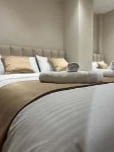 two beds with towels on top of them in a bedroom at Nina's Home in Shkodër