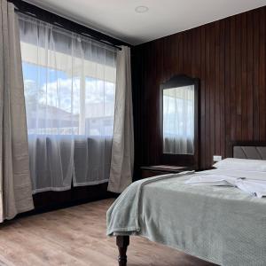 Postelja oz. postelje v sobi nastanitve Hotel Naralit